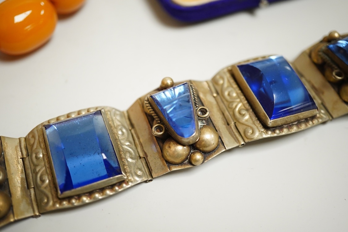 A group of antique and later jewellery inc. cased paste set spray brooch, a Mexican paste set brooch, a paste set shoe buckle and a pressed amber necklace.